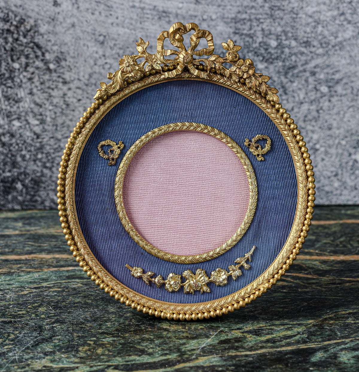 Antique Louis XVI Style Round Gilt Bronze Frame | Ribbon Bow and Flower Crest, Blue Silk Mount, Applied Garlands