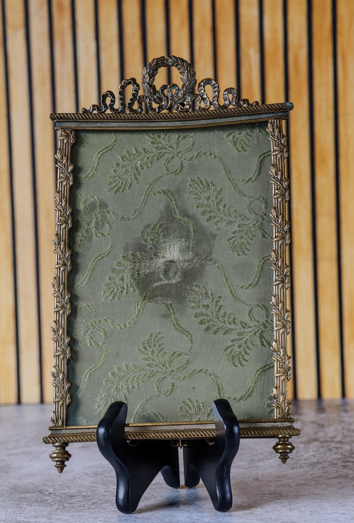 Antique French Louis XVI Style Gilt Bronze Photo Frame with Laurel Wreath and Ribbon Crest, Rope-Twist Border and Green Damask Mount, c. 1880–1900