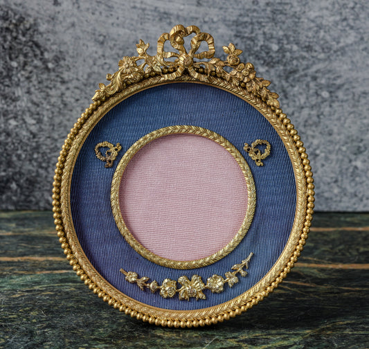 Antique Louis XVI Style Round Gilt Bronze Frame | Ribbon Bow and Flower Crest, Blue Silk Mount, Applied Garlands